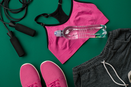 Workout plan with fitness food and sport equipment on green background, top view. Copy space. Still lifeの写真素材