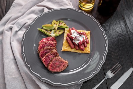 Sliced Fillet mignon beef steak with grilled vegetables on a plate. Original serving of the dish from Chefの写真素材