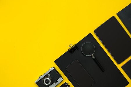 Black objects from the office on a yellow background. Work and creativity. Top view.の写真素材