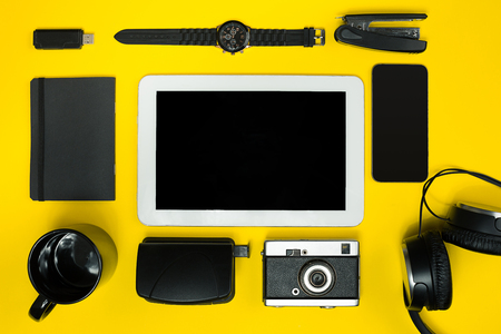 Black objects from the office on a yellow background. Work and creativity. Top view.の写真素材