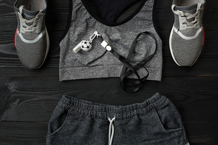 Sports equipment and wear on dark wooden background, top viewの写真素材