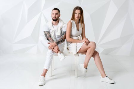 Shot of a fashionable couple posing at studio.の写真素材