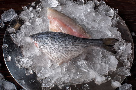Seafood cooking preparation. Top view of dorado fillet on ice.の写真素材