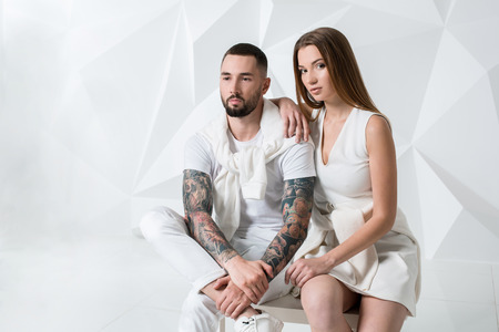 Shot of a fashionable couple posing at studio.の写真素材