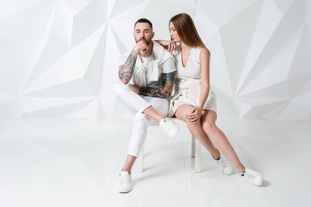 Shot of a fashionable couple posing at studio.の写真素材