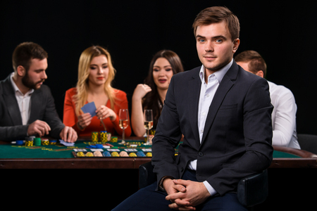 Young people playing poker at the table. Casinoの写真素材