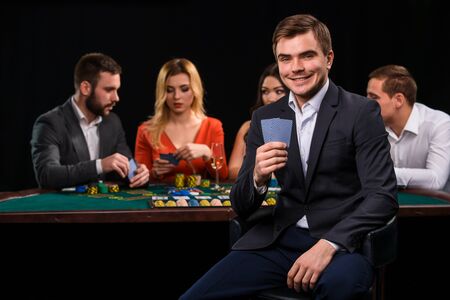 Young people playing poker at the table. Casinoの写真素材