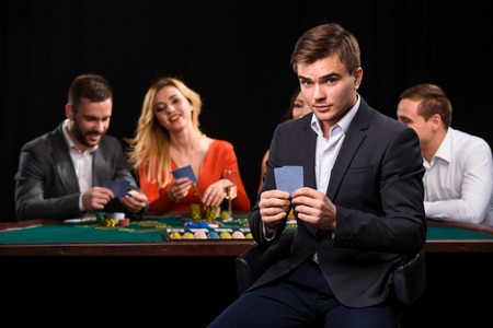 Young people playing poker at the table. Casinoの写真素材