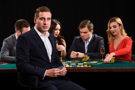 Young people playing poker at the table. Casinoの写真素材