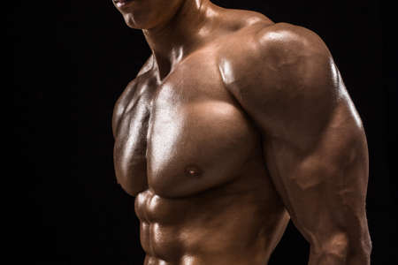 Part of a mans body on a dark background with copyspaceの写真素材