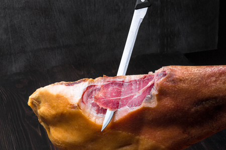Jamon. Jamon serrano. Traditional Spanish ham on black close up.の写真素材