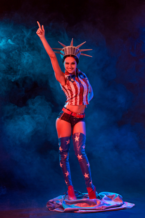 Young woman in stage costume of striptease dancer posingの写真素材