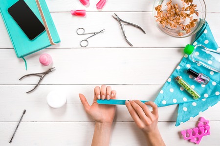 Manicure set and nail polish on wooden backgroundの写真素材