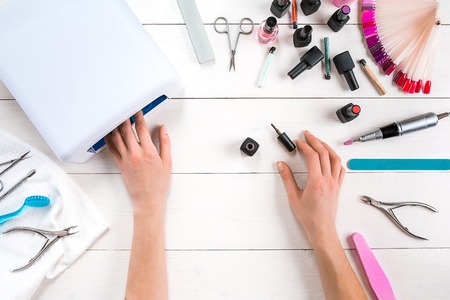 Manicure set and nail polish on wooden backgroundの写真素材