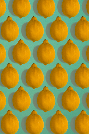 Lemon pattern isolated on blue background. Flat lay
