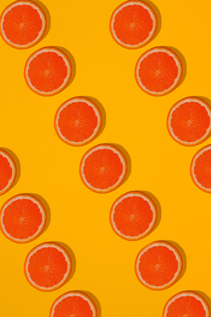 Grapefruit pattern on yellow background. Minimal flat lay concept. Printの写真素材