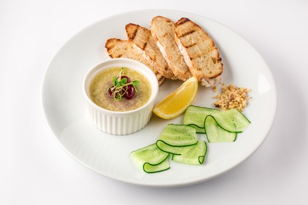 Duck liver pate with croutons, slices of lemon and thinly sliced cucumberの写真素材