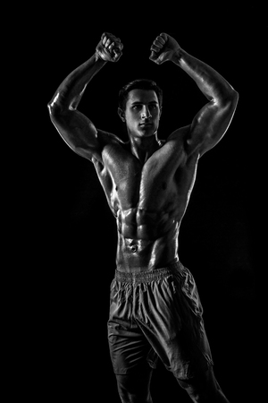 Muscular and fit young bodybuilder fitness male model posing oveの写真素材
