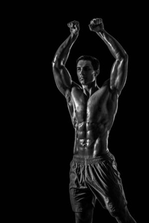 Muscular and fit young bodybuilder fitness male model posing oveの写真素材