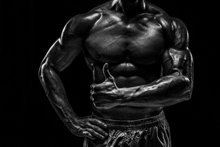 Part of a mans body on a dark background with copyspaceの写真素材