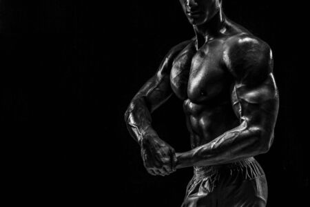 Part of a mans body on a dark background with copyspaceの写真素材