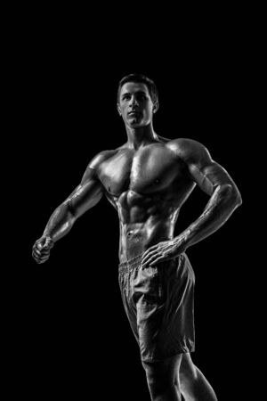 Muscular and fit young bodybuilder fitness male model posing oveの写真素材