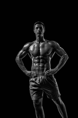 Muscular and fit young bodybuilder fitness male model posing oveの写真素材