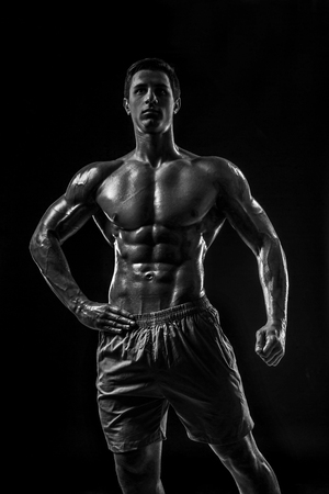 Muscular and fit young bodybuilder fitness male model posing oveの写真素材