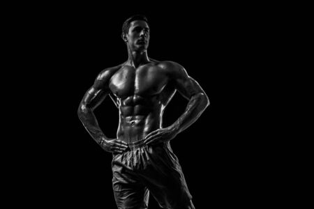 Muscular and fit young bodybuilder fitness male model posing oveの写真素材