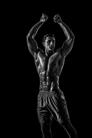 Muscular and fit young bodybuilder fitness male model posing oveの写真素材