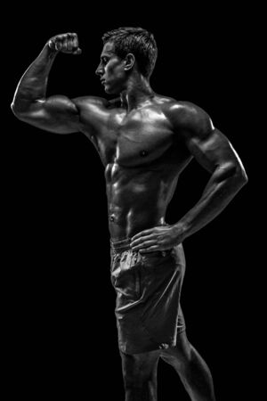 Muscular and fit young bodybuilder fitness male model posing oveの写真素材