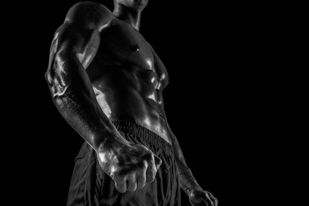 Part of a mans body on a dark background with copyspaceの写真素材