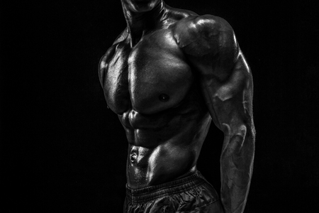 Part of a mans body on a dark background with copyspaceの写真素材