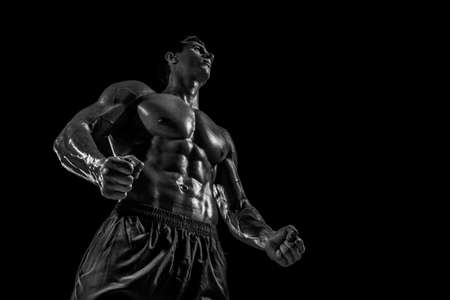 Muscular and fit young bodybuilder fitness male model posing oveの写真素材