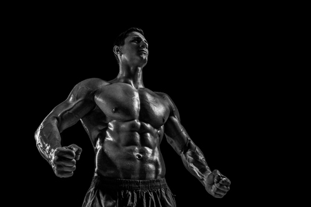 Muscular and fit young bodybuilder fitness male model posing oveの写真素材