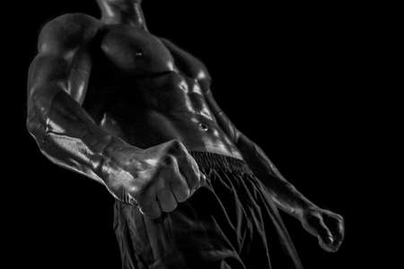 Part of a mans body on a dark background with copyspaceの写真素材