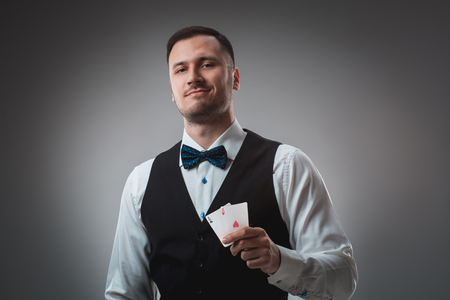 Handsome confident man holding cards looking at camera.の写真素材