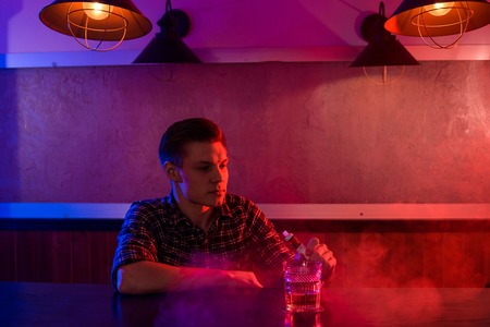 The man smoke an electronic cigarette at the vape shop.の写真素材