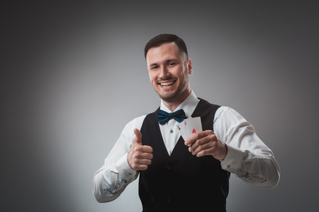 Handsome confident man holding cards looking at camera.の写真素材