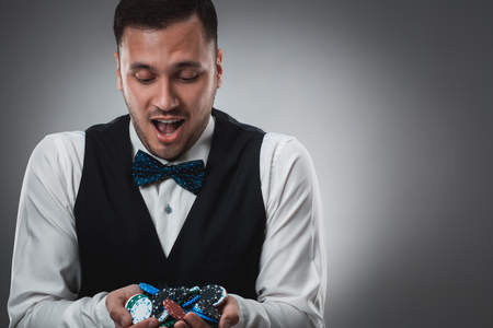 Poker player taking poker chips after winningの写真素材