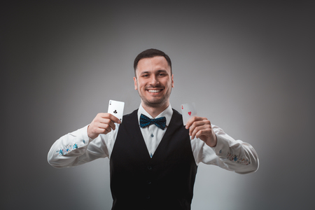 Handsome confident man holding cards looking at camera.の写真素材