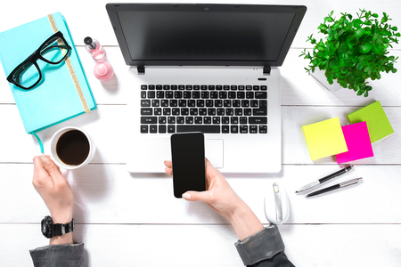 Overhead view of businesswoman working at computer in officeの写真素材