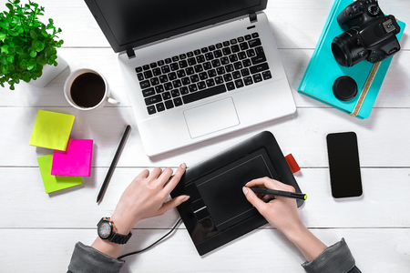Overhead view of businesswoman working at computer in officeの写真素材