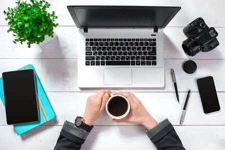 Overhead view of businesswoman working at computer in officeの写真素材
