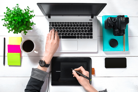 Overhead view of businesswoman working at computer in officeの写真素材