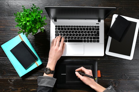 Overhead view of businesswoman working at computer in officeの写真素材
