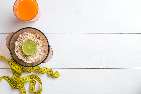Breakfast with oatmeal and juice on white backgroundの写真素材