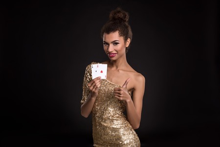 Pretty african girl shows two aces in casino poker and winの写真素材