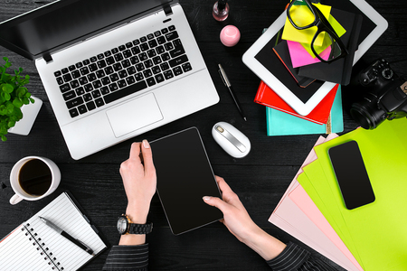 Overhead view of businesswoman working at computer in officeの写真素材