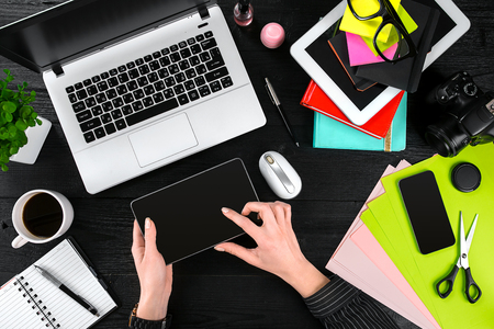 Overhead view of businesswoman working at computer in officeの写真素材